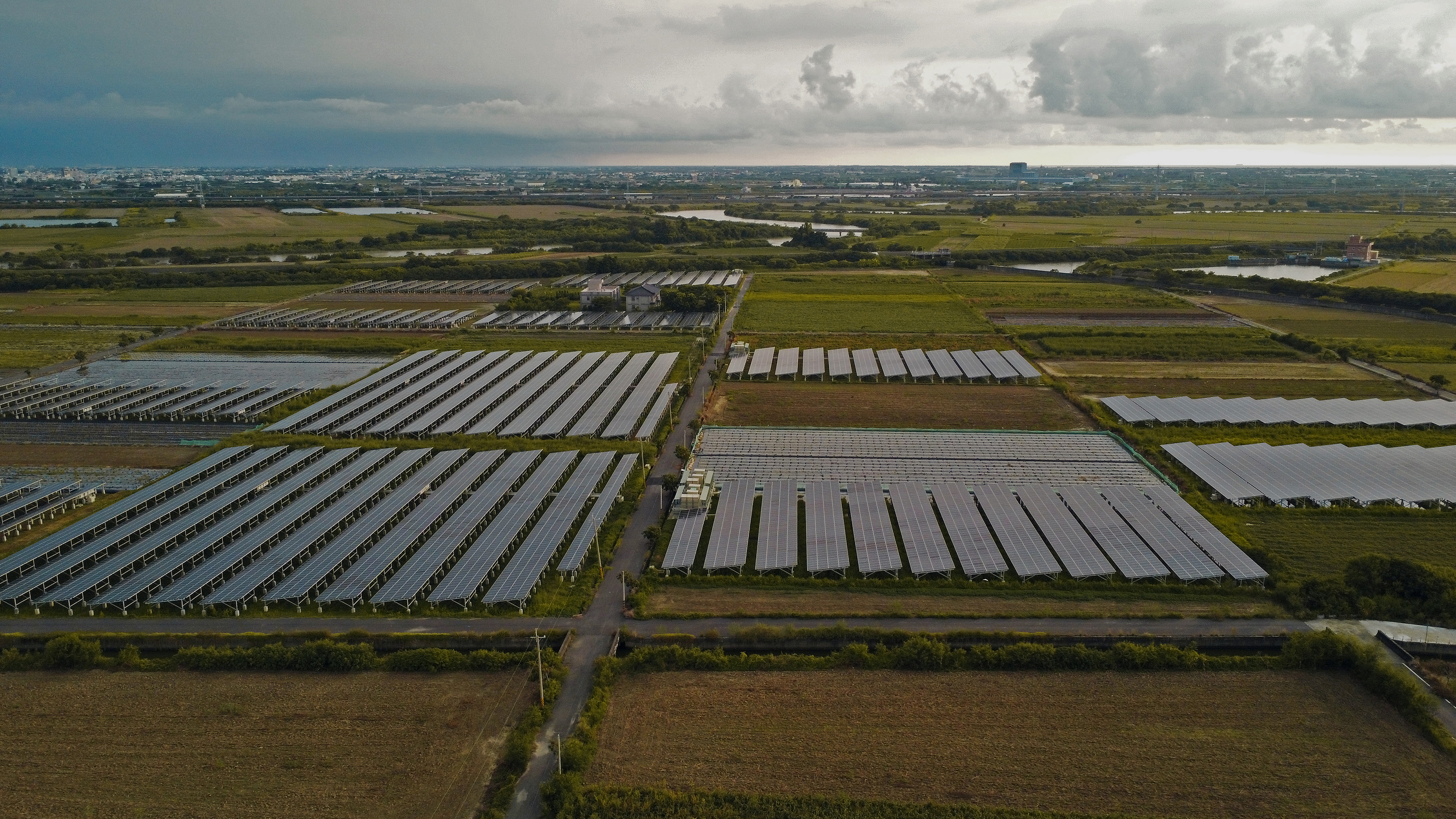 Utility-scale solar arrays replacing farmland in Tainan, Taiwan.